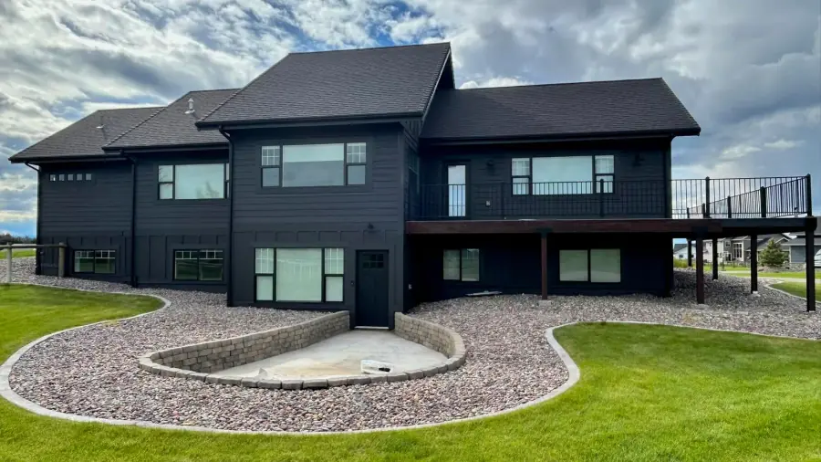 Modern residential exterior finished in a deep charcoal paint color.