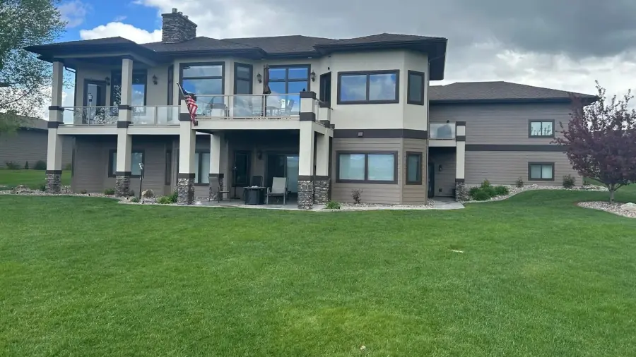 Residential exterior with a completed light two-tone painted finish.
