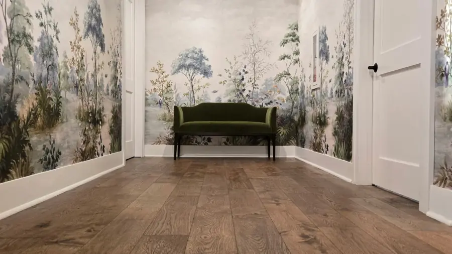 Botanical mural wallcovering surrounding a green bench in a residential hallway.
